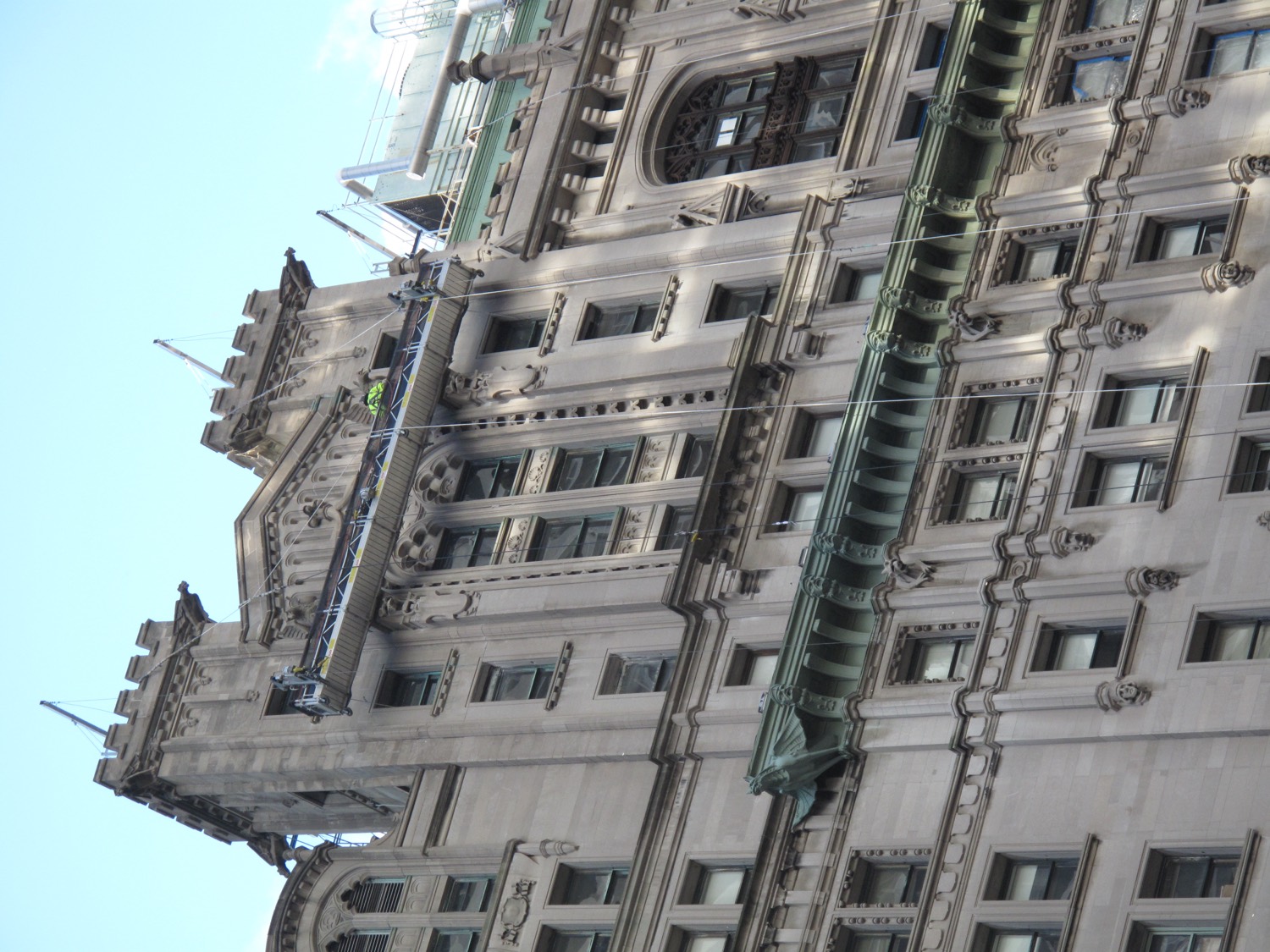 Titan crew on a suspended platform restoring the copper cornice at a landmark facade crown